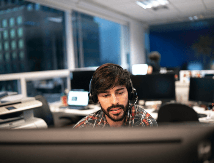 man wearing headset working in a call center